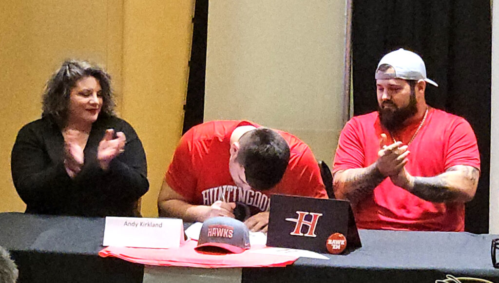 Oxford’s Andrew Kirkland puts pen to paper during Oxford’s National Signing Day ceremony Wednesday. (Photo by Joe Medley)