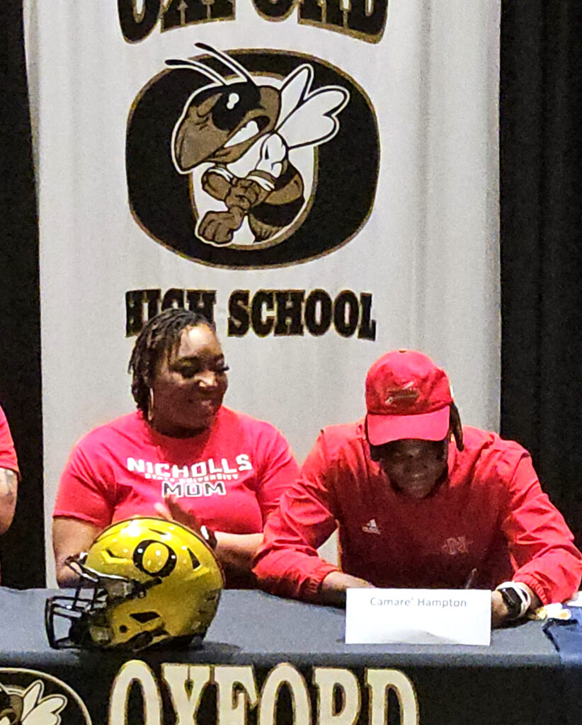 Oxford’s Camare Hampton puts pen to paper during Oxford’s National Signing Day celebration Wednesday. (Photo by Joe Medley)