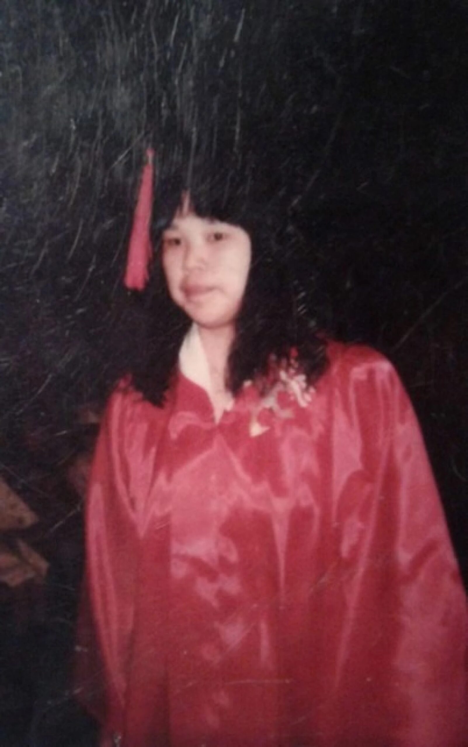 a woman in a graduation cap and gown