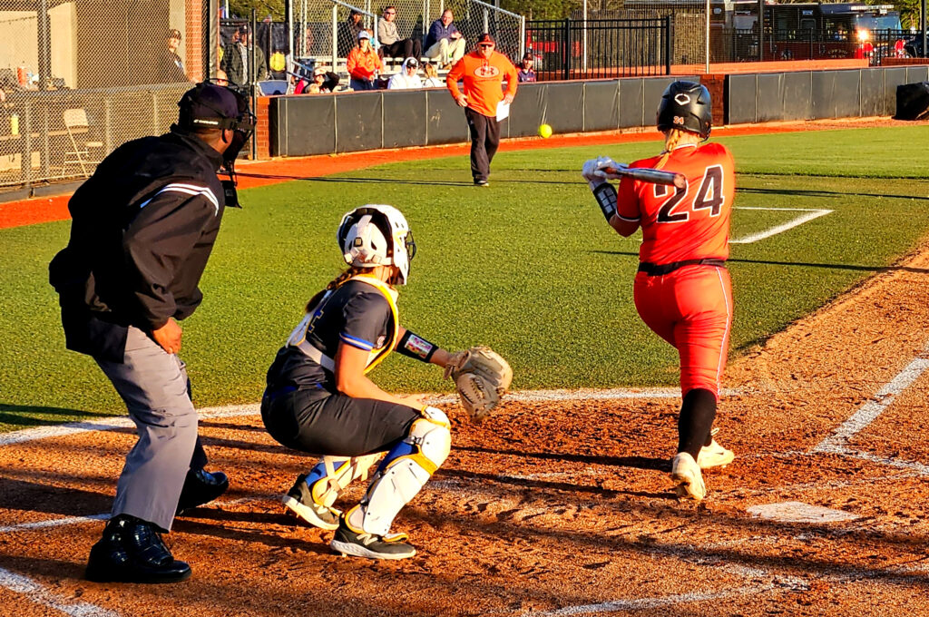 Alexandria’s Pressley crushes a foul ball in the direction of her coach, Brian Hess, during Friday’s Calhoun County final at Choccolocco Park. (Photo by Joe Medley)